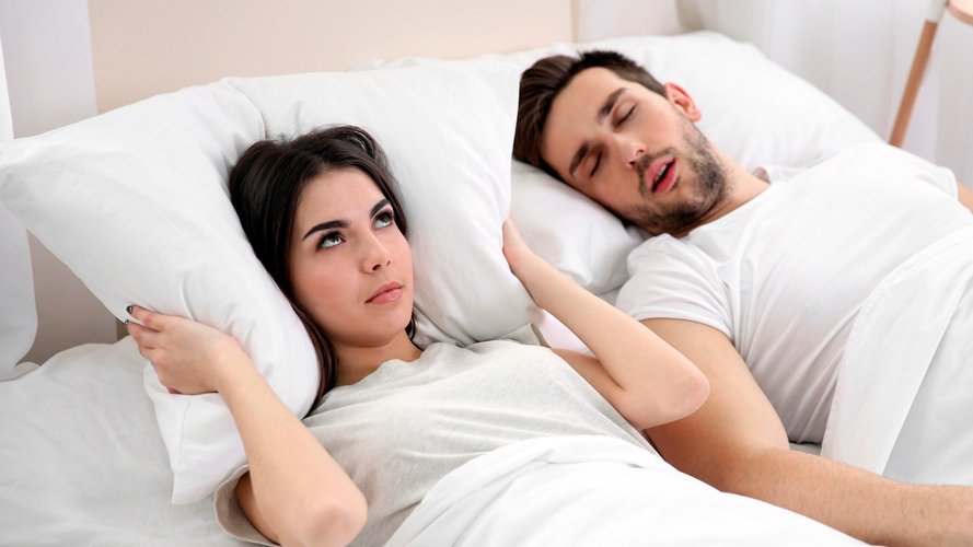 Man snoring in bed