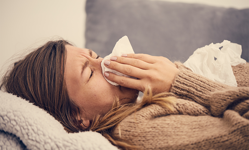 Woman blowing her nose - Link Between Allergic Rhinitis and Sleep Apnoea | SleepTest.co.uk