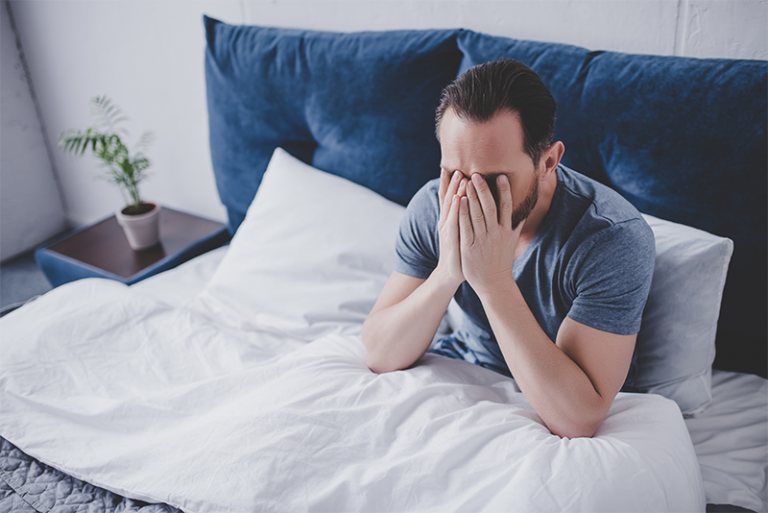 Stressed man in bed